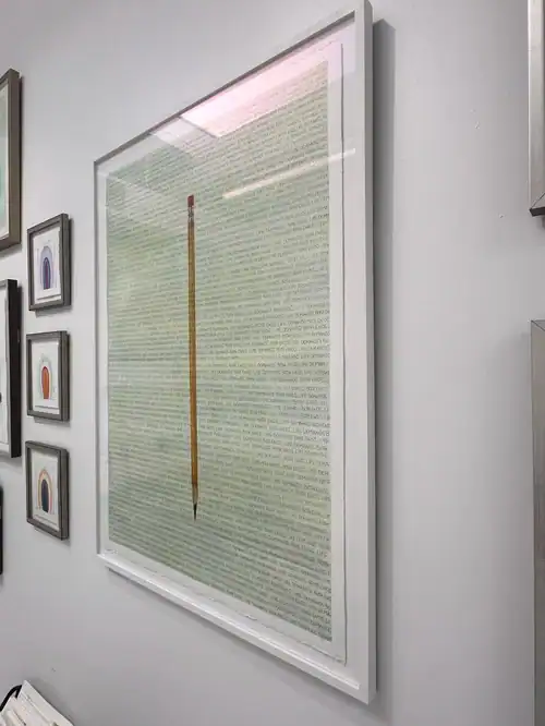 An artwork titled "Life Demands on Both Ends" featuring a large text-based piece with a centered pencil illustration.