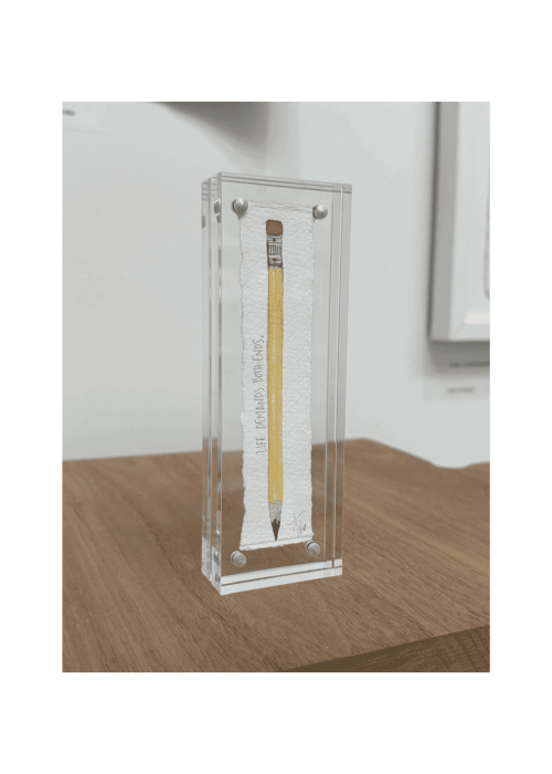 Pencil with "Life Demands on Both Ends" handwritten, encased in a clear acrylic display. Symbolizes life's balanced pressures and responsibilities.