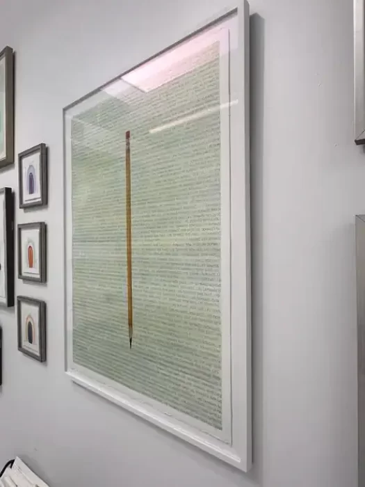 An artwork titled "Life Demands on Both Ends" featuring a large text-based piece with a centered pencil illustration.